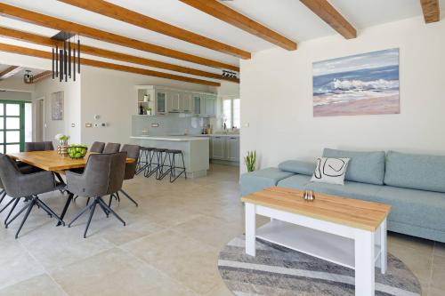 a living room with a blue couch and a table at Villa Vego by Rent Istria in Muntrilj