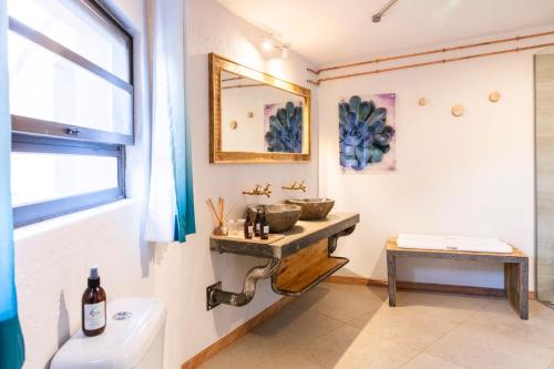 a bathroom with a sink and a mirror at Barkhan Dune Retreat in Solitaire