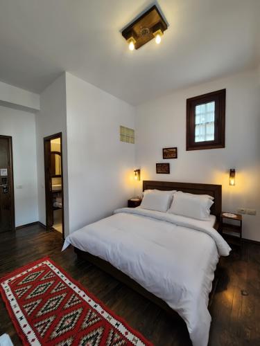 a bedroom with a large white bed in a room at Sokak Boutique Hotel in Berat