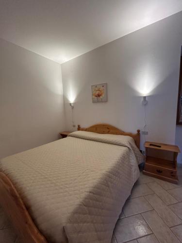 a bedroom with a bed and a nightstand next to it at Agriturismo Bellavista in Ronzano