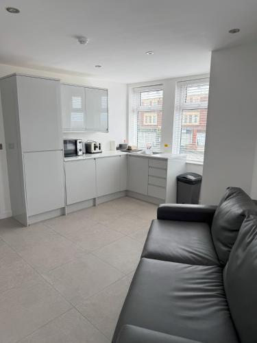 a living room with a couch and a kitchen at Coastal Plaza in Blackpool
