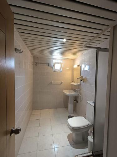 a bathroom with a toilet and a sink at Kleopatra Carmen Apart Hotel in Alanya