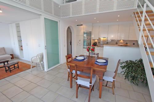 a kitchen and dining room with a table and chairs at Orizzonte Blu by HolAp SA in Gambarogno