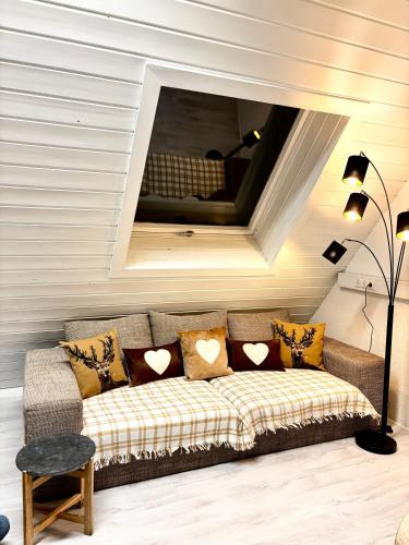 a couch with pillows on it in a room at Lechtaler Alpenblick Landeck - Privatzimmer & Ferienwohnung in Landeck
