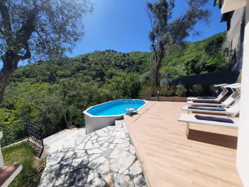 a backyard with a swimming pool and a deck at "Blue Villa" with private pool,BBQ in Andora in Moltedo