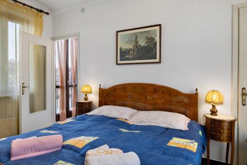 a bedroom with a blue bed with two towels on it at Casa Dello Zio Birba in Portacomaro