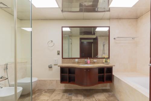 a bathroom with a sink and a mirror at 1-bedroom apartment with pool in Dubai
