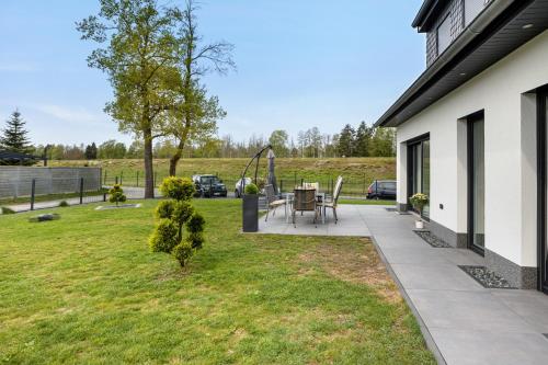 a backyard with a table and a playground at Ferienwohnung Bresser Bernsteinsee in Sassenburg