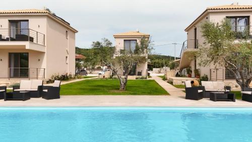 a view of a villa with a swimming pool at Three Charites Resort in Gialova