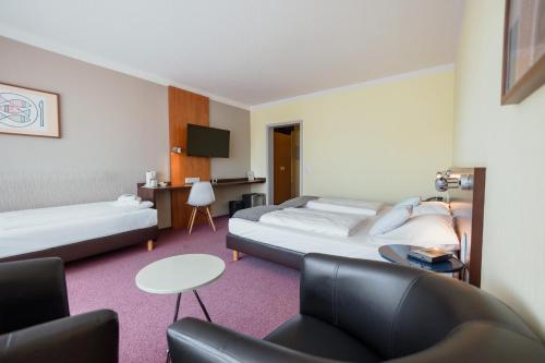 Postel nebo postele na pokoji v ubytování Best Western Hotel Ambassador