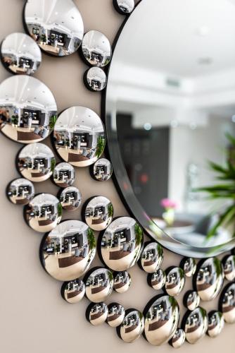 a mirror on a wall with reflections of houses in it at Hotel Polonia in Biała Podlaska