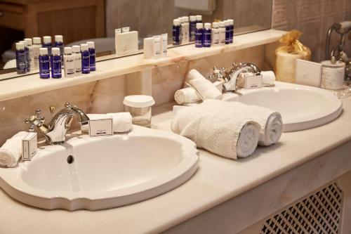 a bathroom with two sinks and towels on a counter at Hayfield Manor in Cork