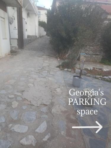 a driveway with the words georgia parking space at Georgia's in Ayía Kiriakí
