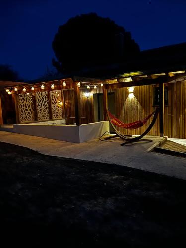 a house with a hammock outside at night at Le Mas de Scott in Espeluche