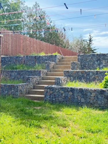 a set of stone stairs next to a fence at FamilyVilla, new 4 Luxury Big Apartments, parking in Prague