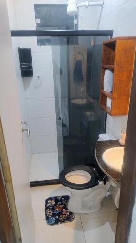 a bathroom with a toilet and a sink at River House in Marau
