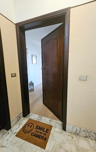 an open door with a smile dental center sign in a room at Sara&Pietro's Home in Diano Marina
