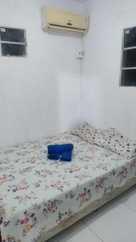 a bed with a blue pillow on it in a room at River House in Marau
