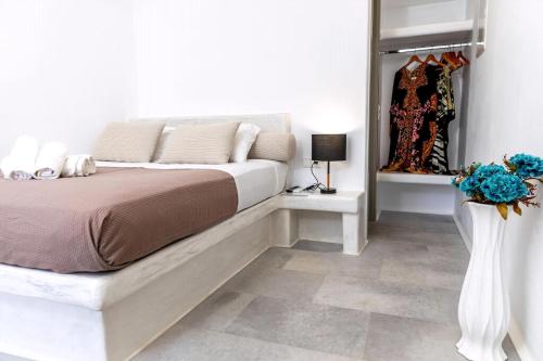 a bedroom with a bed and a vase with flowers at Depis Place And Apartments Naxos Depis Castle Renata Luxury Apartments-Double Studio in Naxos Chora