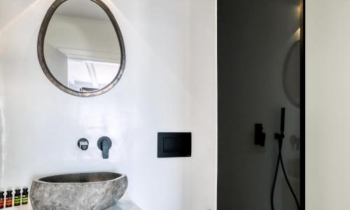 ein Badezimmer mit einem Waschbecken und einem Spiegel in der Unterkunft Magnificent Mykonos Villa Villa Rikei 5 Bedrooms Unique Aegean Sea Views in Psarrou