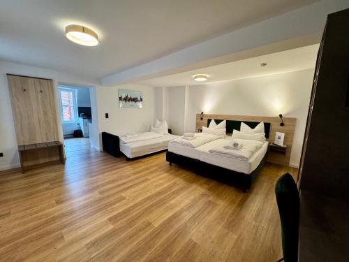 a large room with two beds and a couch at Hopfenhotel am Adenauerufer in Bamberg