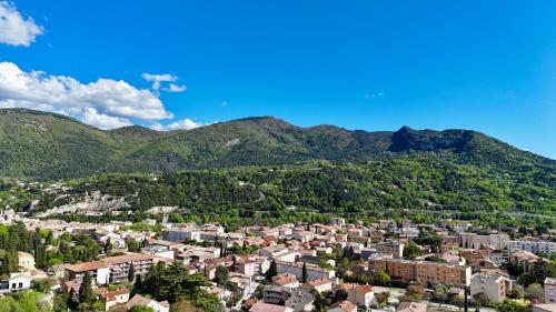 an aerial view of a town with mountains in the background at Villa La Lézardière in Nyons