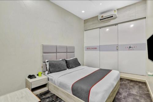 a bedroom with a large bed in a room at Hotel Unicorn, Surat in Surat
