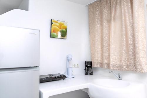 a bathroom with a sink and a window at Luxury Naxos Suites Superior Apartment With Balcony Steps Away From The Main Square Saint George in Naxos Chora