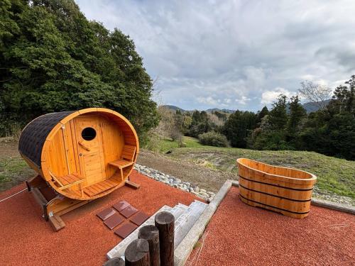 a large wooden boat sitting on top of a field at サウナパラダイス富山 in Minamiboso