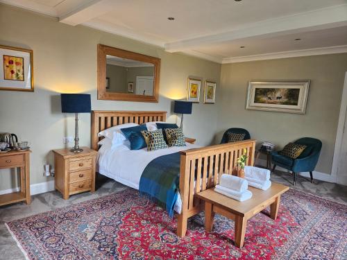 a bedroom with a bed and a table and a mirror at Craggan in Ballater
