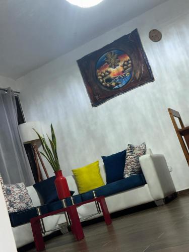 a living room with a couch and a painting on the wall at Casa Mariana in Las Terrenas