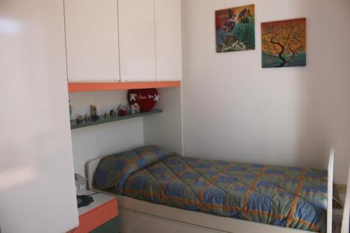 a bedroom with a bed and some shelves at le case dei Pescatori Le coralline in Isola di Gavi