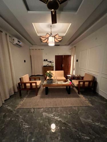 a living room with a couch and a table at Gita Bhawan - Elegant Escape in Haridwār