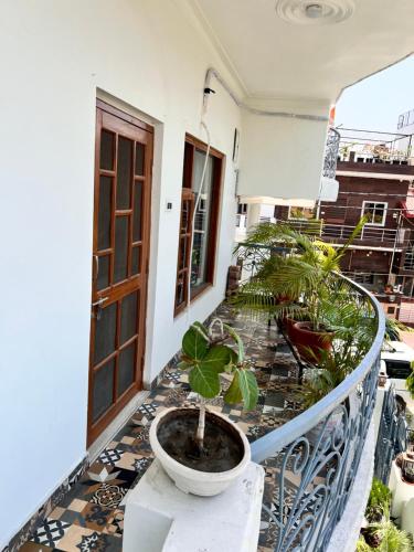 a potted plant on the balcony of a house at Gita Bhawan - Elegant Escape in Haridwār