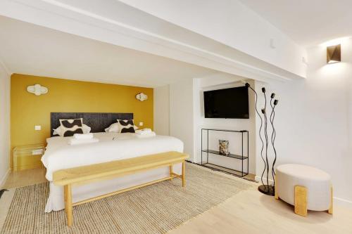 - une chambre avec un grand lit et une télévision dans l'établissement Duplex Cosy Canal Saint Martin, à Paris