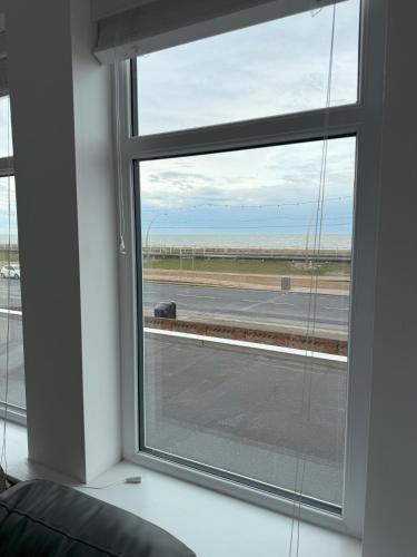 a window in a room with a view of an airport at Coastal Plaza in Blackpool