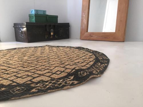 a rug sitting on the floor in a room at Cute Antiparos Villa 1 Bedroom Villa Sunset Amazing Sea Views in Andiparos