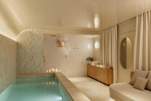 a swimming pool in a living room with a couch at Hôtel De Buci in Paris