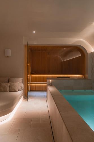 a room with a pool and a bed and a tub at Hôtel De Buci in Paris