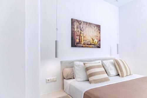a bedroom with a bed with a painting above it at Premium Naxos Suite Family Suite With Private Balcony Modern Furnishing in Naxos Chora