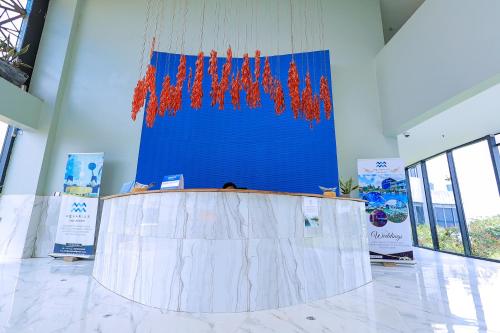a large table in a room with a blue wall at Aquarius Kigo Resort in Kigo