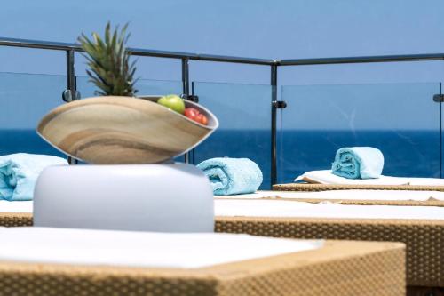 a bowl of fruit sitting on top of a table at Ikaria Beachfront Villa 7 Bedrooms Villa Indigo Blue Haven Infinity Pool With Stunning Aegian Sea Views Gialiskari in Gialiskari