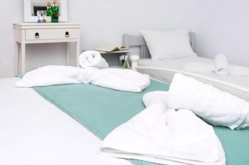 a room with two beds with white towels at Superb Naxos Apartment Triple Studio Semi-Basement Private Balcony City Views Saint George in Naxos Chora
