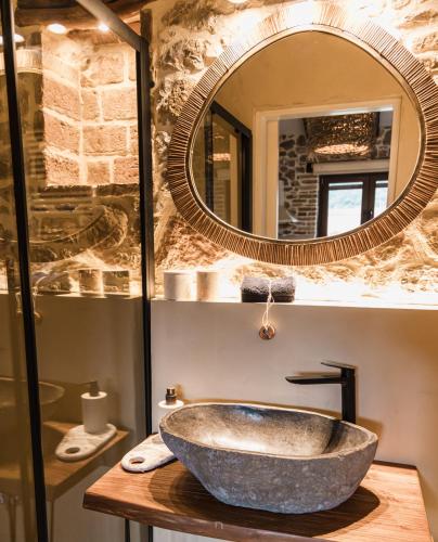 a bathroom with a stone sink and a mirror at Μάραθος in Kalavrita