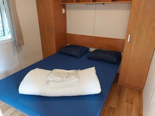 a room with a bed with towels on it at Camping Alkenhaer Appelscha Chalet 034 in Appelscha