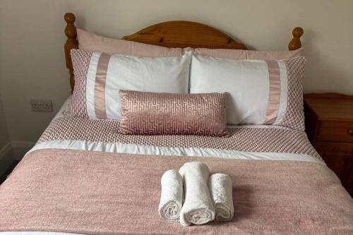 a bed with two pairs of slippers on it at Nature Lovers Family Home - 3 Bed 2 Bath in Colthurst Bridge