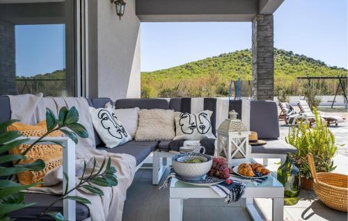 a patio with a couch and a table with food on it at Beautiful Home In Stankovci With Wifi in Stankovci