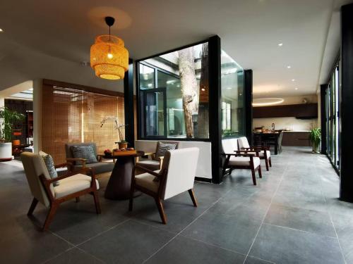 华阴Hidden Spring Entire 7 Bedroom Mountain Villa Near Huashan for Families and Groups的大楼内摆放着桌椅的大厅