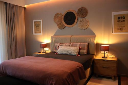 a bedroom with a bed with hats on the wall at One Luxury House Above The Sea in Plakias