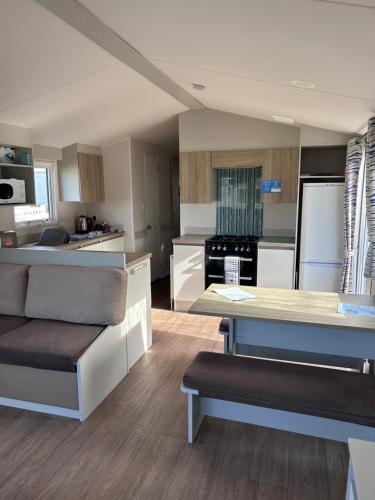 a kitchen with white cabinets and a counter top at Haven Cala gran 2026 spring summer autumn winter breaks up to January 2027 A full action camp for all ages disabled friendly Fleetwood Blackpool Entire home 6 people seaside caravan park in Fleetwood